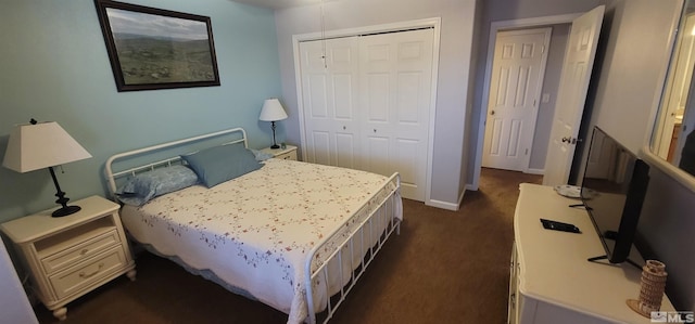 bedroom featuring dark colored carpet and a closet