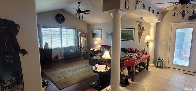 interior space featuring decorative columns, ceiling fan, and lofted ceiling