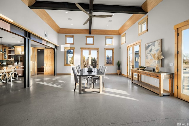 dining area with beam ceiling, ceiling fan, french doors, and a towering ceiling