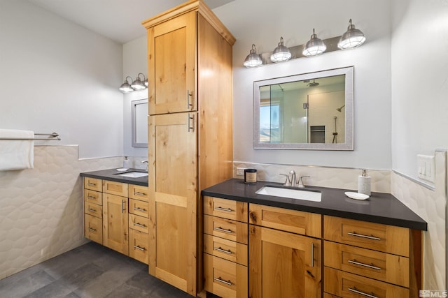 bathroom featuring vanity and tile walls