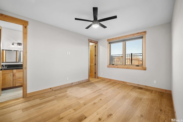 unfurnished bedroom with light hardwood / wood-style floors, ceiling fan, and sink