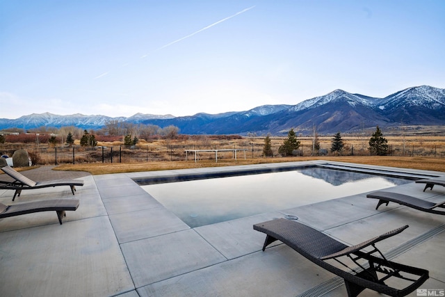 view of swimming pool with a mountain view and a trampoline