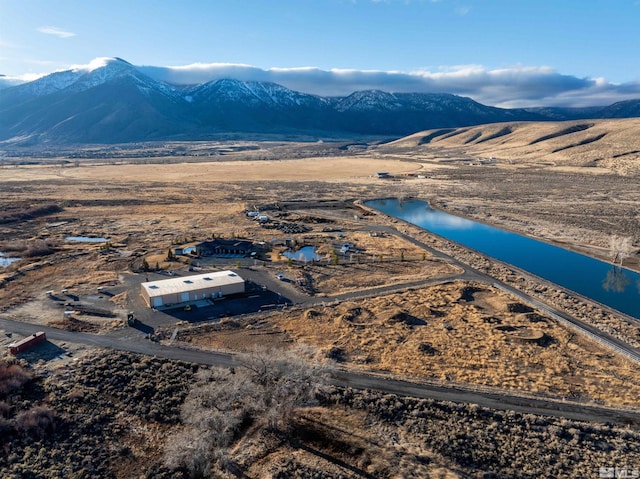 drone / aerial view with a water and mountain view