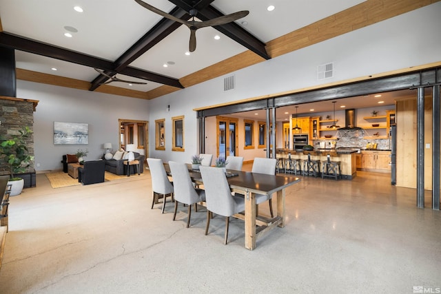 dining space featuring ceiling fan, beam ceiling, a high ceiling, and coffered ceiling