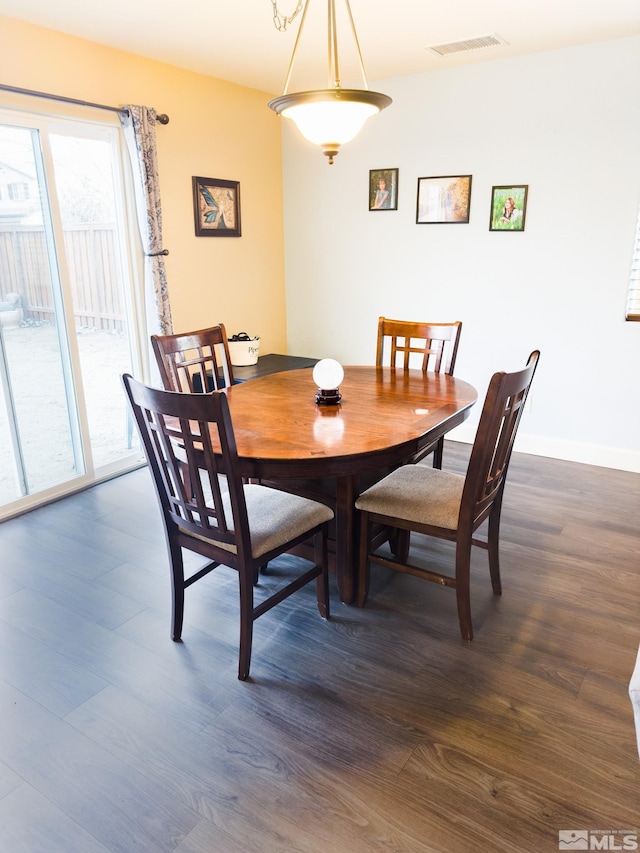 dining room with dark hardwood / wood-style flooring