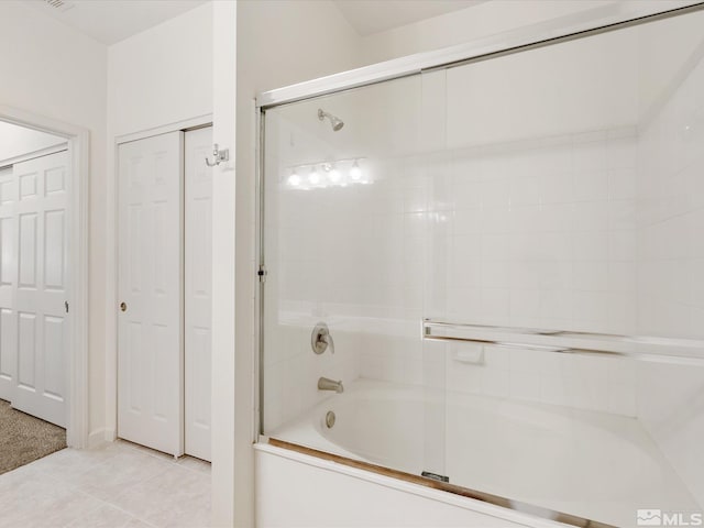 bathroom with tile patterned floors and combined bath / shower with glass door