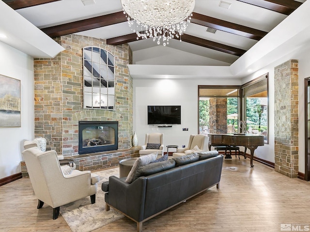 living room featuring a chandelier, lofted ceiling with beams, light hardwood / wood-style floors, and a fireplace