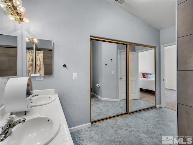 bathroom featuring vanity and lofted ceiling