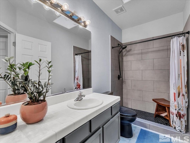 bathroom with vanity, toilet, and curtained shower