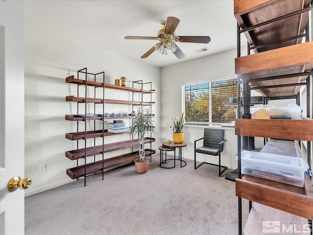 miscellaneous room with ceiling fan and light carpet