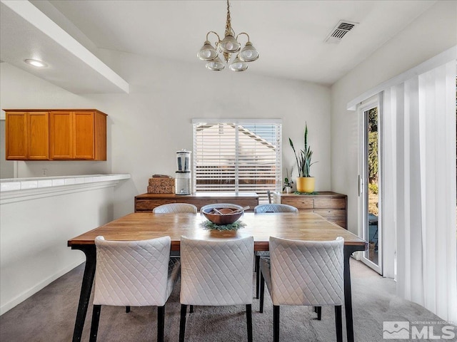 dining area with a notable chandelier, lofted ceiling, light carpet, and a wealth of natural light