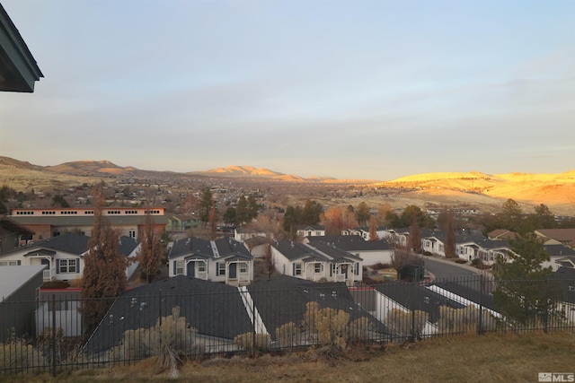 aerial view at dusk featuring a mountain view