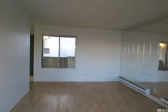 empty room featuring light hardwood / wood-style flooring and baseboard heating