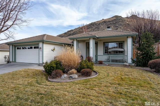 single story home featuring a front yard, a porch, and a garage