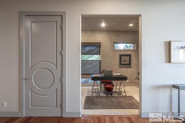 corridor with light hardwood / wood-style flooring