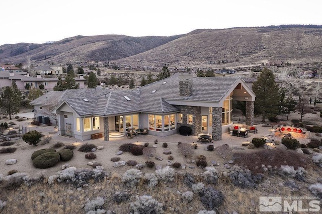 view of front of property with a mountain view and central air condition unit