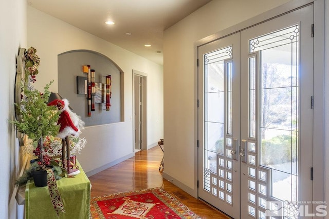 doorway with french doors and wood-type flooring