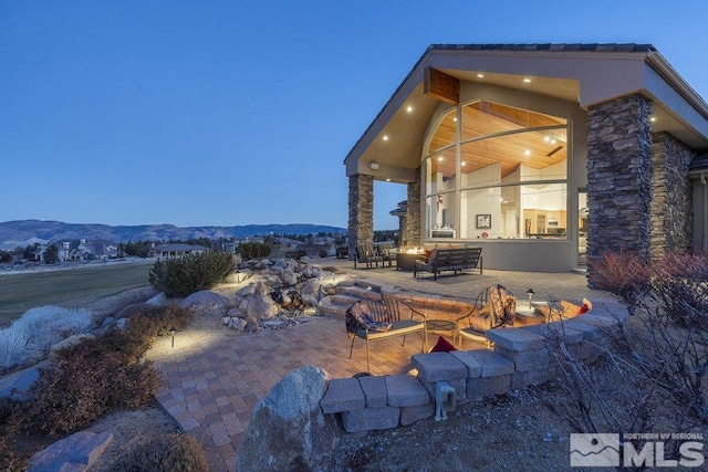 patio terrace at dusk with a mountain view