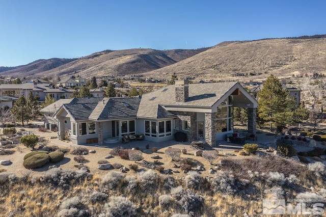 back of house with a mountain view