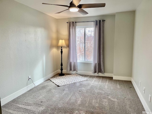 spare room featuring carpet flooring and ceiling fan