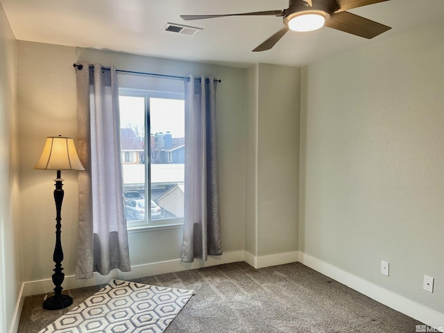 spare room with carpet floors and ceiling fan