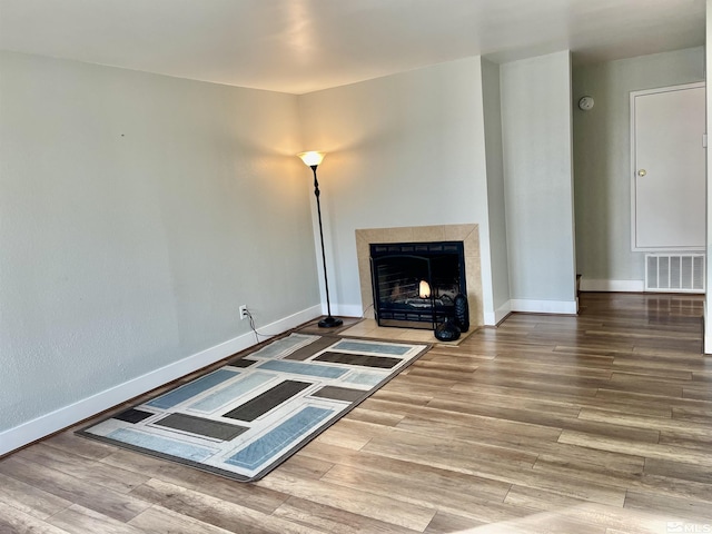 unfurnished living room with a tile fireplace