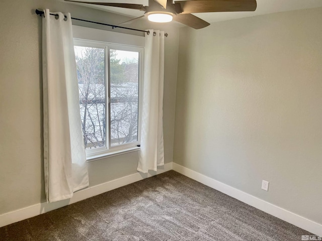 carpeted spare room featuring ceiling fan