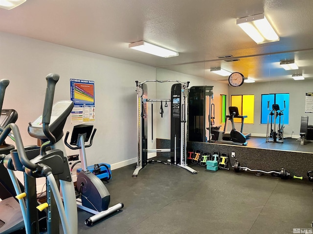 exercise room featuring a textured ceiling