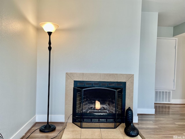 room details with a fireplace and wood-type flooring