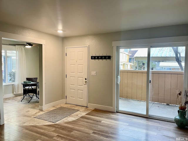 foyer entrance with light hardwood / wood-style flooring and a healthy amount of sunlight