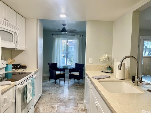 kitchen featuring ceiling fan, white cabinetry, range with electric stovetop, and sink