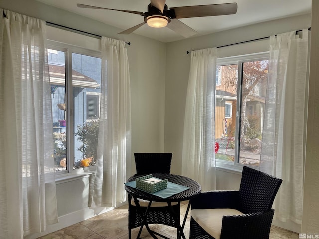 living area featuring ceiling fan and light tile patterned flooring