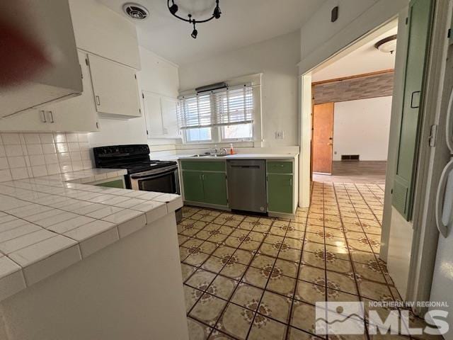 kitchen featuring white cabinetry, electric range, dishwasher, tile countertops, and green cabinetry