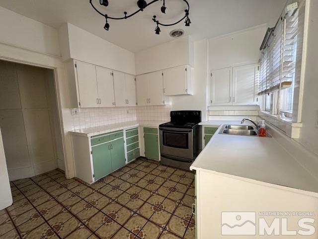 kitchen featuring white cabinets, decorative backsplash, black range with electric stovetop, and sink