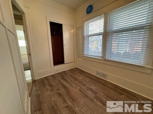 unfurnished room featuring dark hardwood / wood-style flooring