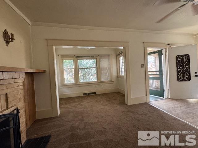 unfurnished living room with carpet flooring, ceiling fan, and ornamental molding