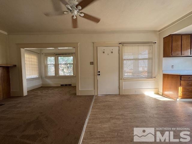 interior space featuring ceiling fan and carpet floors