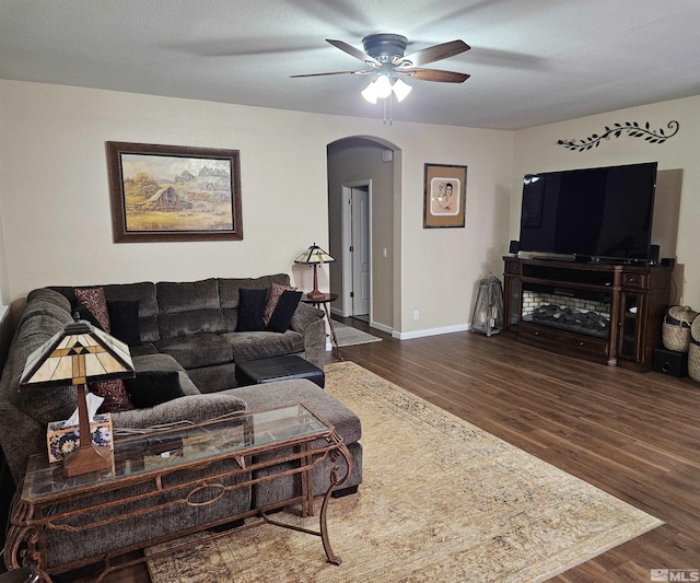 living room featuring ceiling fan, hardwood / wood-style floors, and a textured ceiling