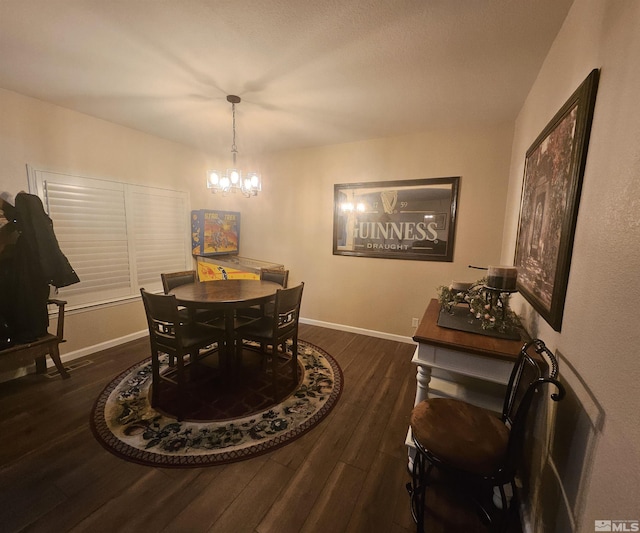 dining space featuring a chandelier and dark hardwood / wood-style floors