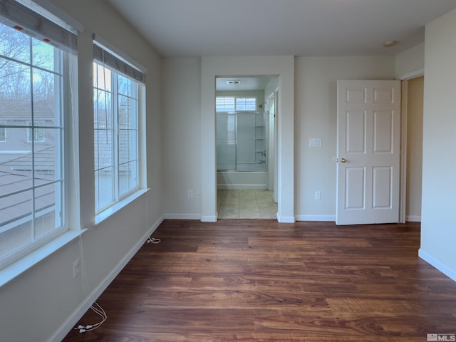 empty room with dark hardwood / wood-style flooring