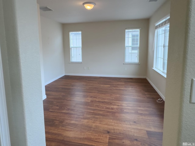 empty room featuring dark wood-type flooring