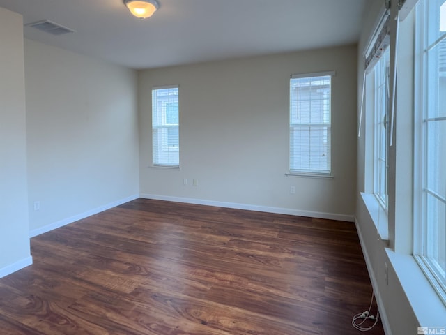 unfurnished room with dark wood-type flooring