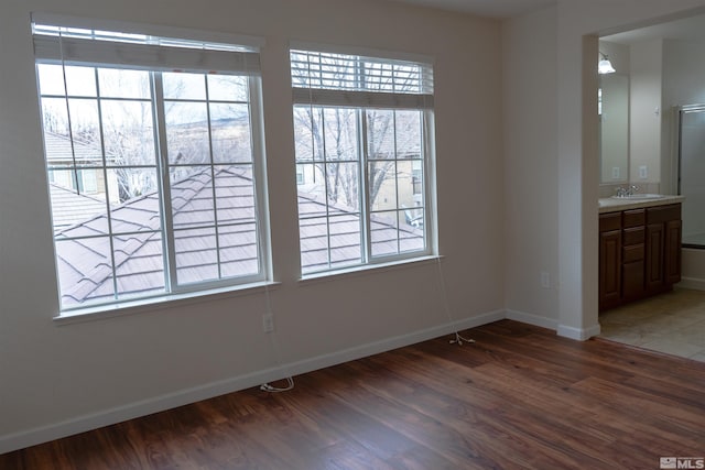 spare room featuring dark hardwood / wood-style floors and sink