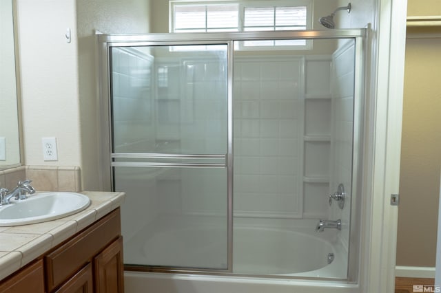 bathroom featuring vanity and enclosed tub / shower combo