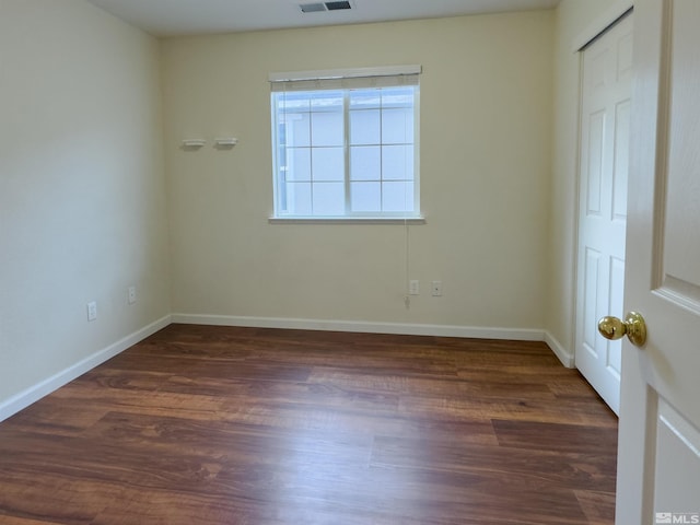 spare room featuring dark hardwood / wood-style flooring