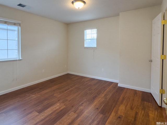 spare room with dark hardwood / wood-style flooring