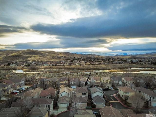 aerial view featuring a water and mountain view