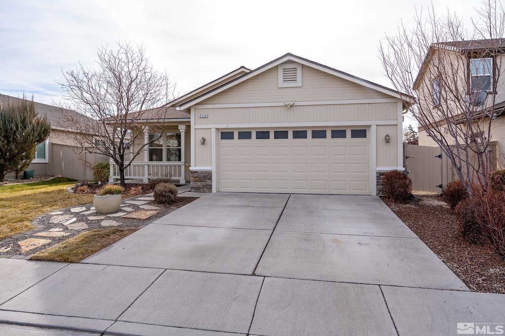 single story home with a porch and a garage