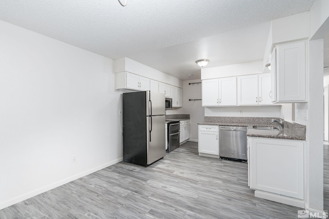 kitchen featuring white cabinetry, sink, a textured ceiling, and appliances with stainless steel finishes