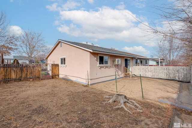 rear view of property featuring an AC wall unit